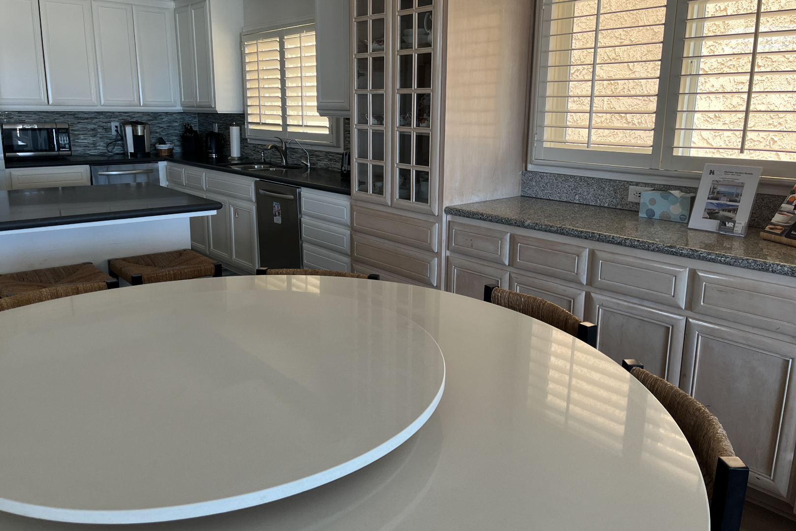 A view of the dining room table with the kitchen in the background
