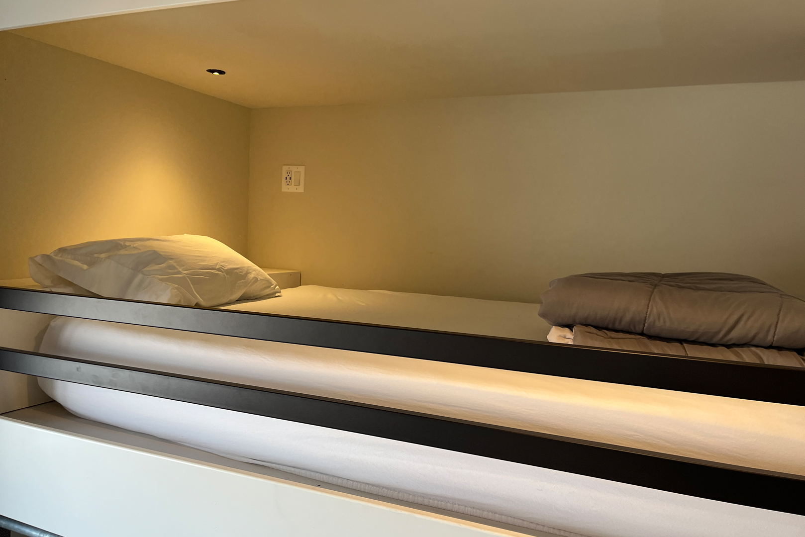 A view of one of the bunk beds in the bunk room. Each bunk has its own outlet with USB and a light